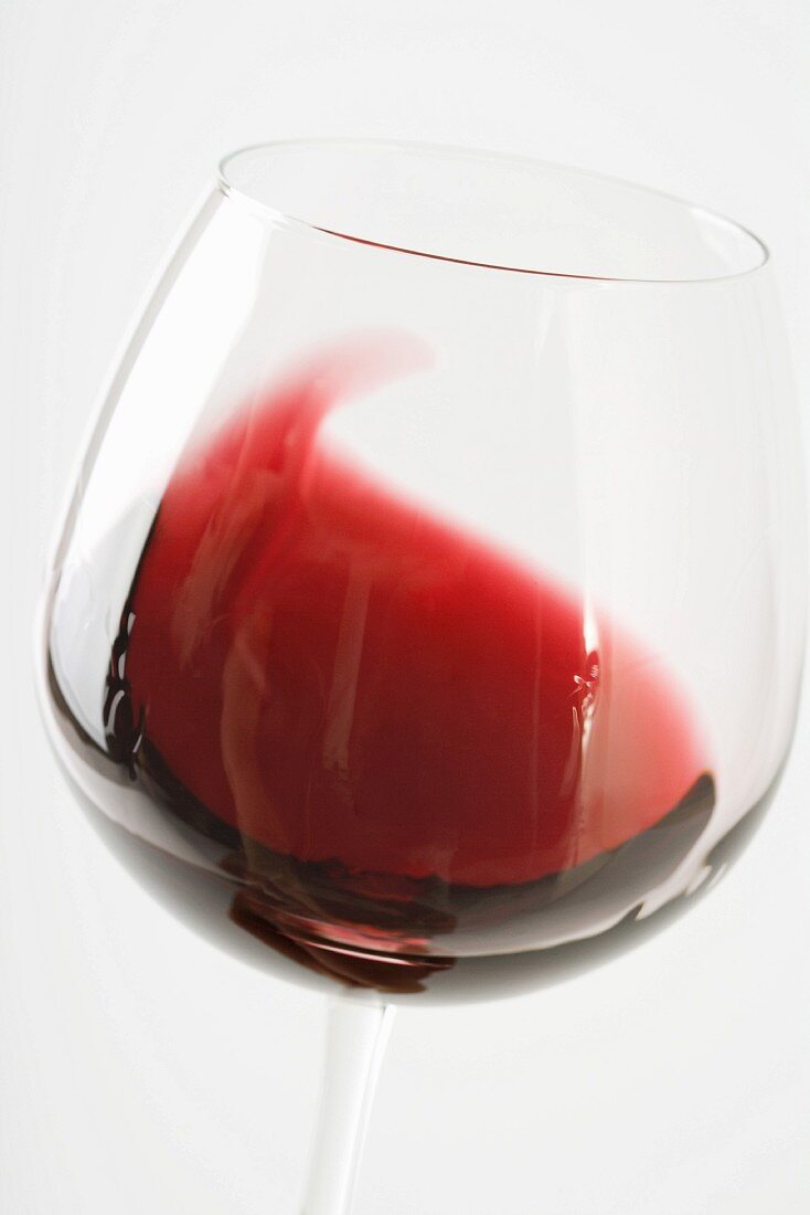 Swirling red wine in glass