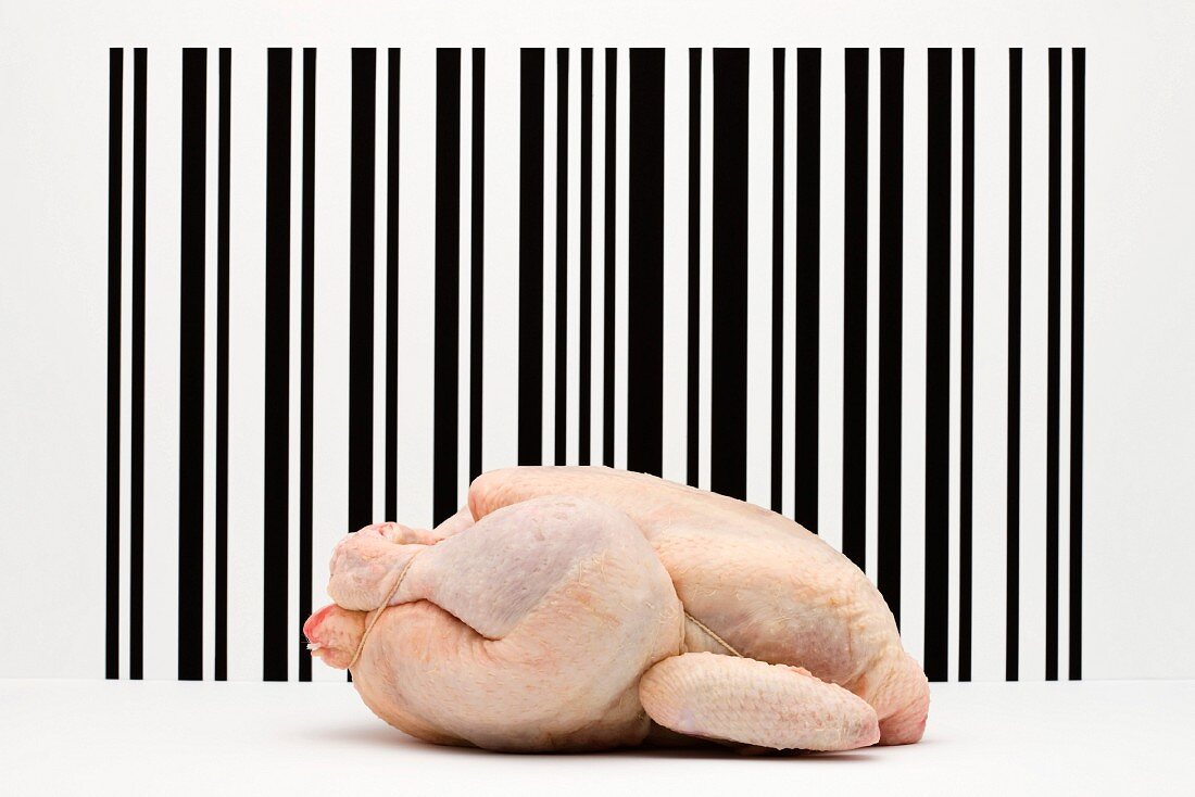 Food concept, raw whole chicken in front of bar code