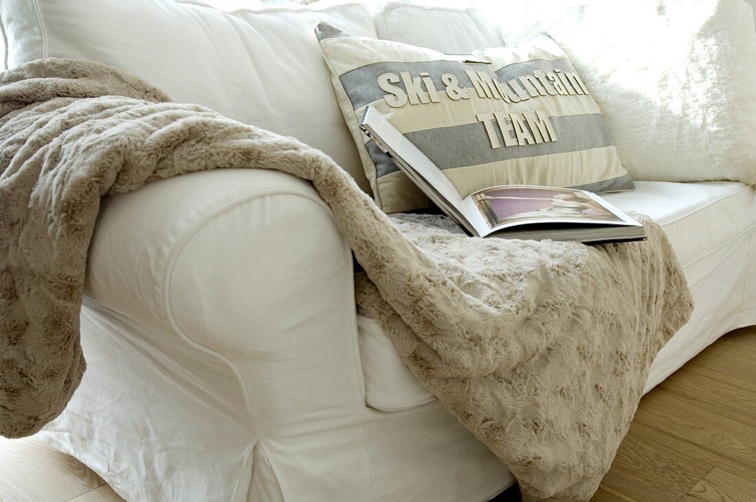 Wolldecke und Kissen auf einer Couch