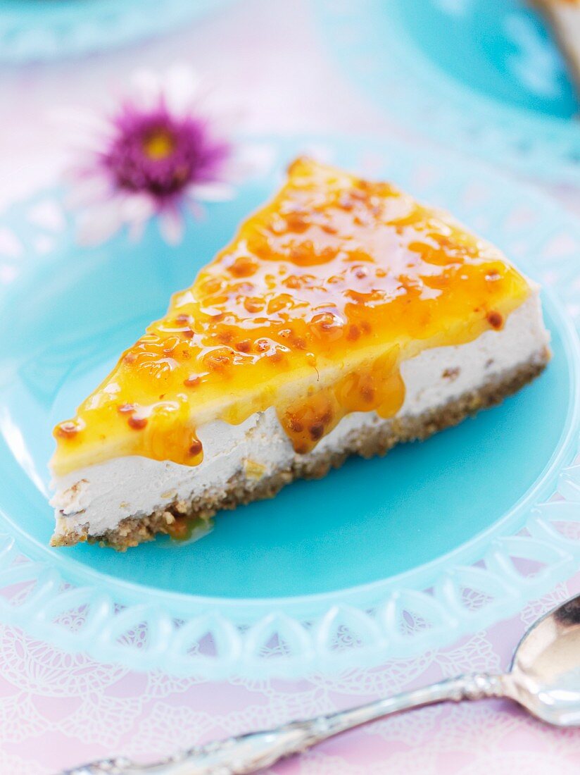 A slice of cheesecake with passion fruit sauce