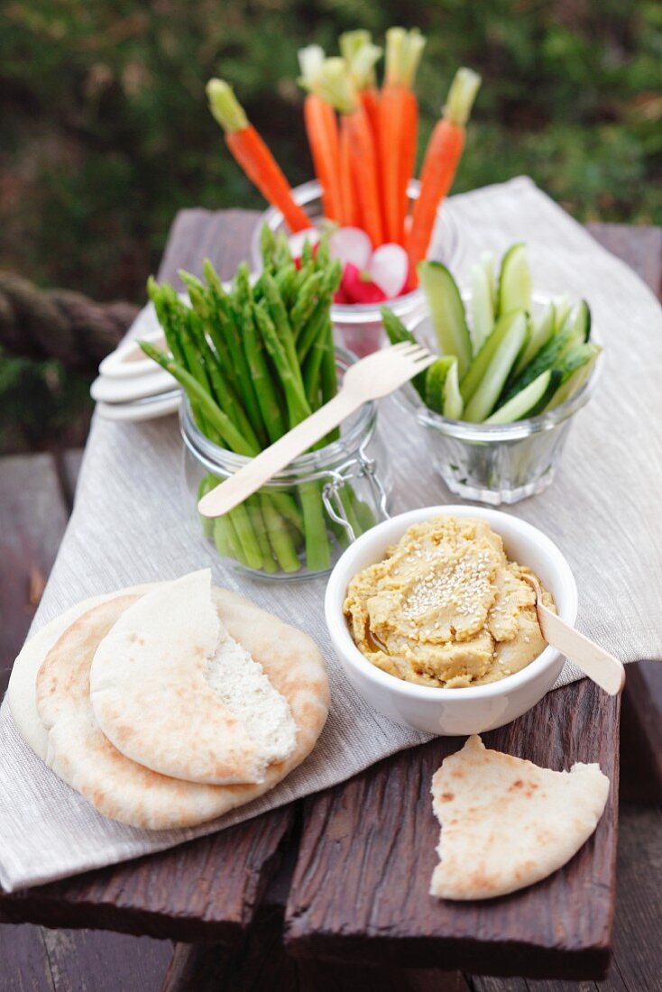 Hummus with raw vegetables and pita bread