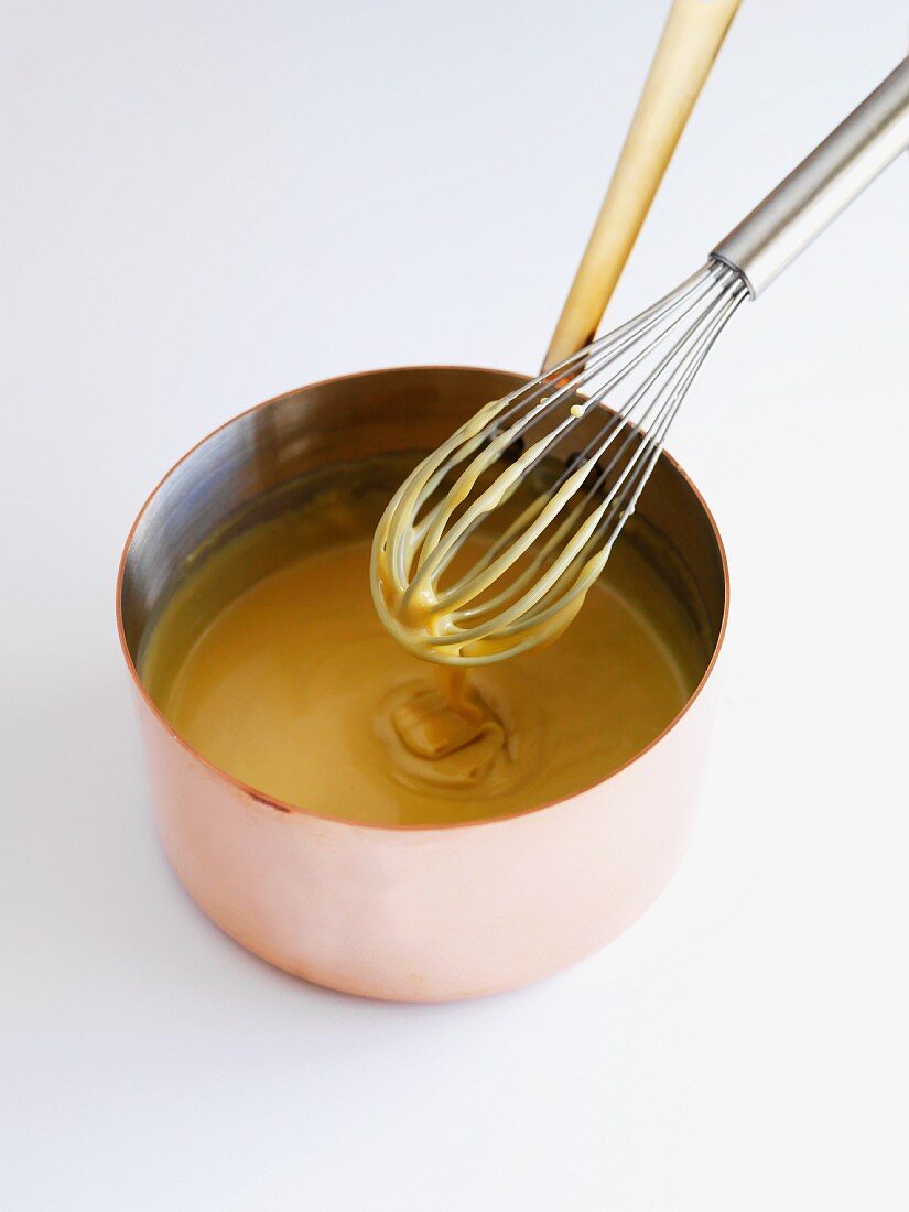 Caramel sauce with whiskey being prepared in a pot