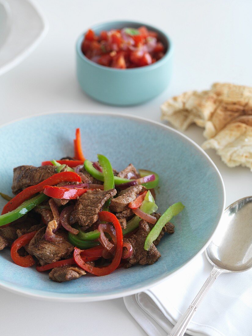 Stir fried beef with pepper and tomato salsa