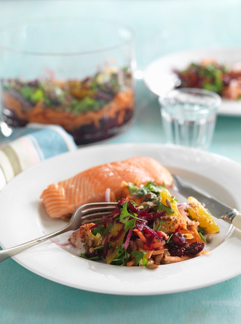 Vegetable salad with beetroot, oranges and carrots with a salmon fillet