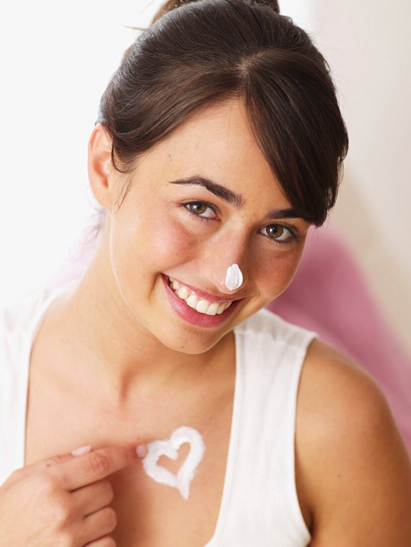 Smiling woman applying creme