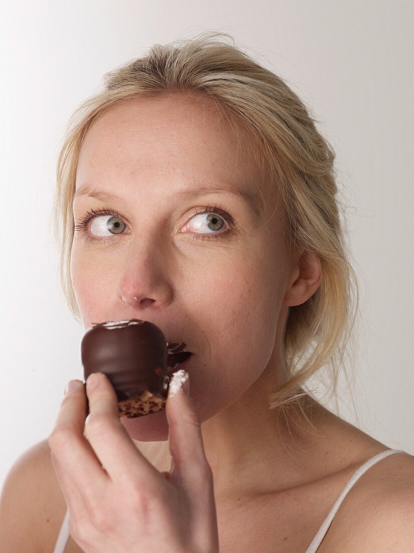 Woman eating chocolate marshmallow