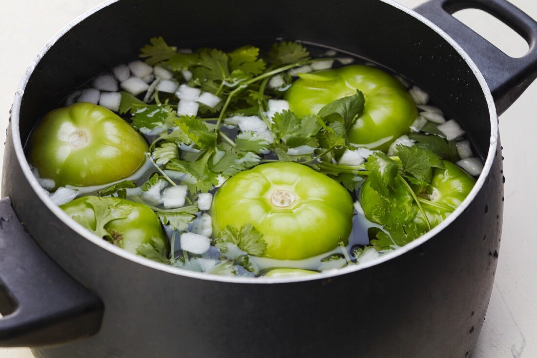 Tomatillos, Onion and Cilantro Soaking in a Pot