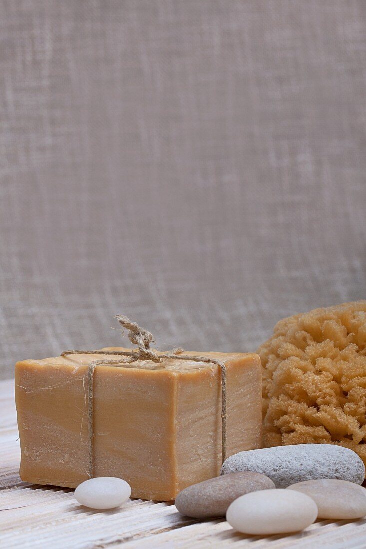 Spa - soaps and pebbles in front of natural sponge