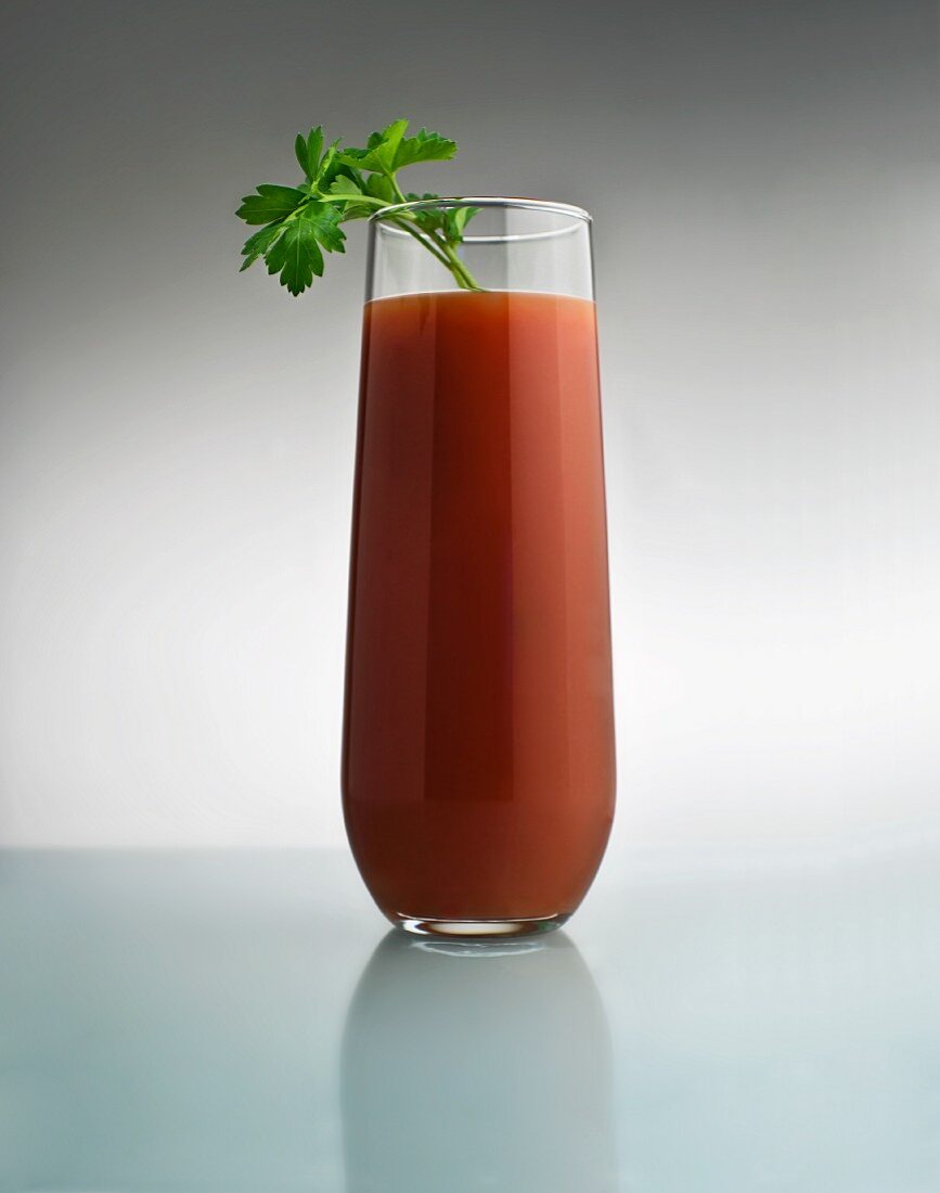 A Bloody Mary in a Tall Glass with Parsley Garnish