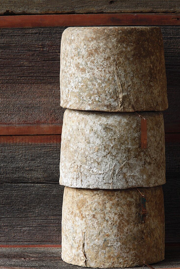 Three Wheels of Aged Sheep Cheese; Stacked