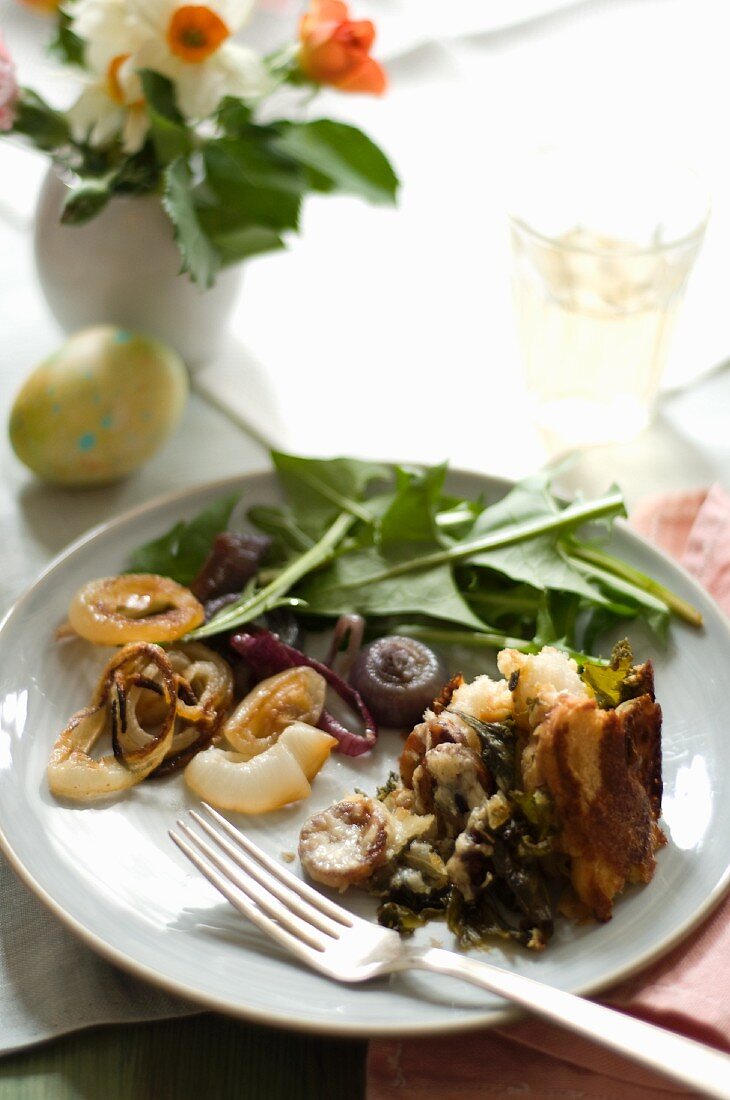 Plate on an Easter Table; Sausage Swiss Chard Strata with Roasted Onion and Dandelion Green Salad