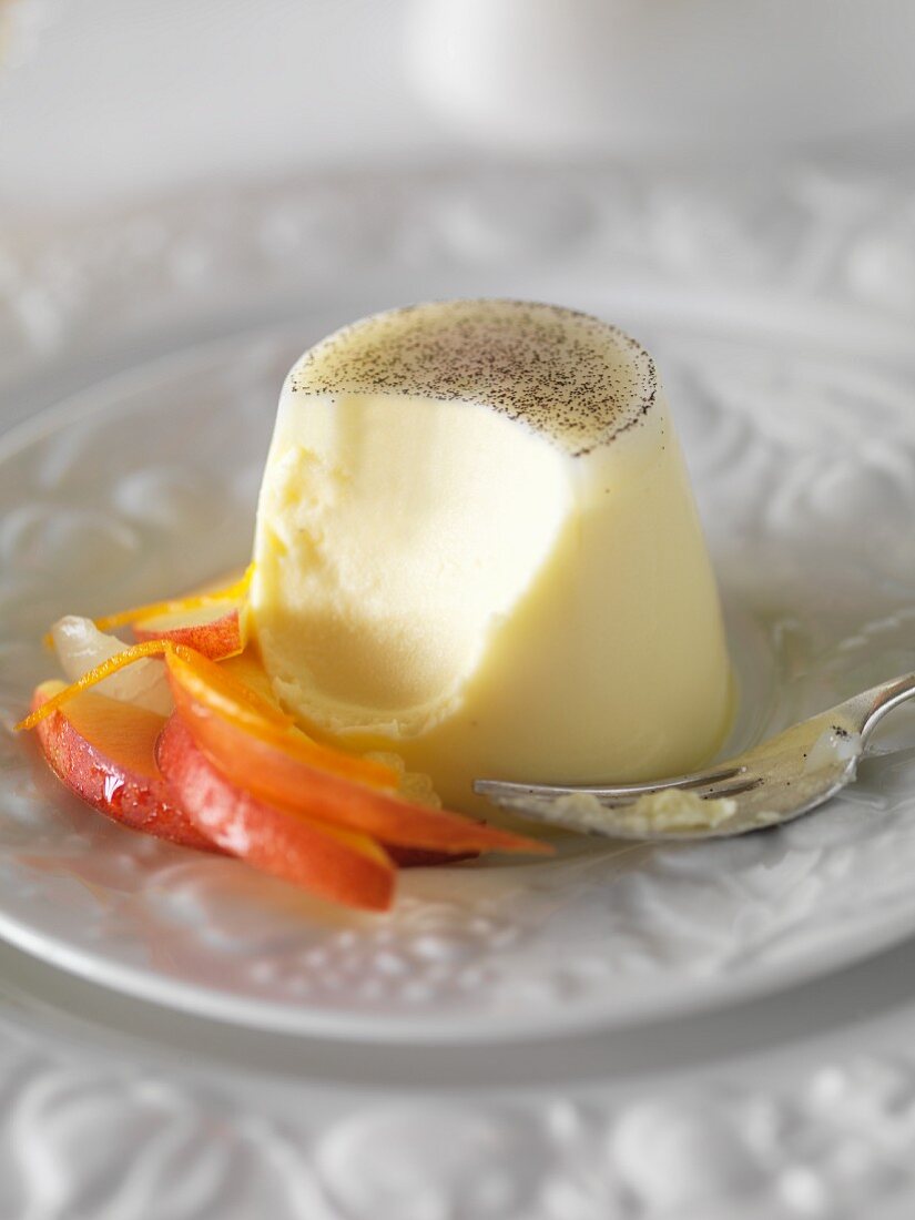 Panna cotta with peach salad with a bite taken out