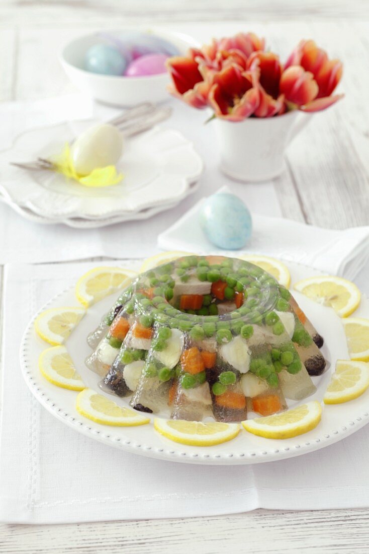 Chicken, quail's eggs, peas, olives and carrots in aspic