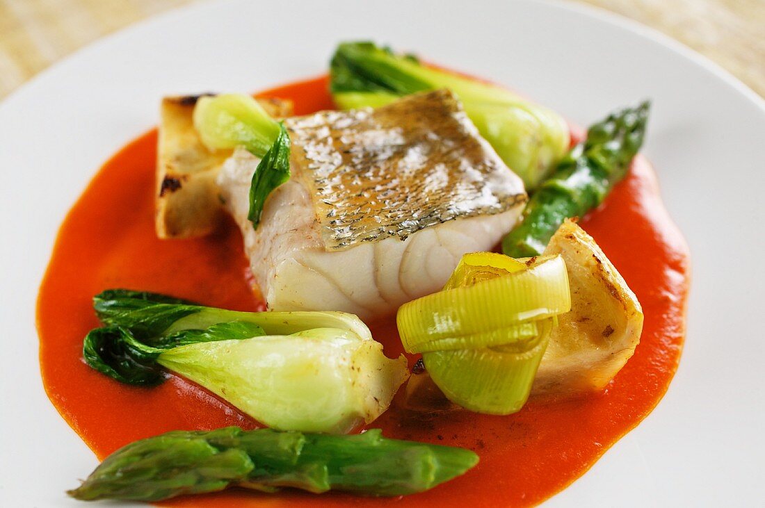 Steamed zander on red pepper creme with vegetables