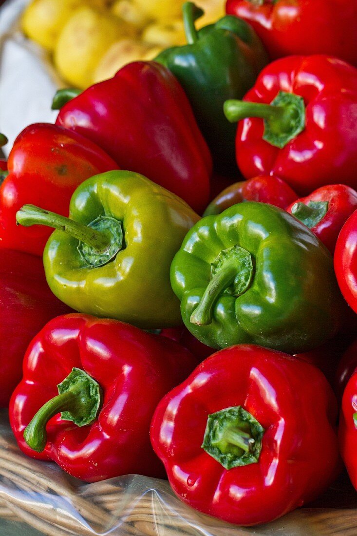 Various different coloured peppers in a basket