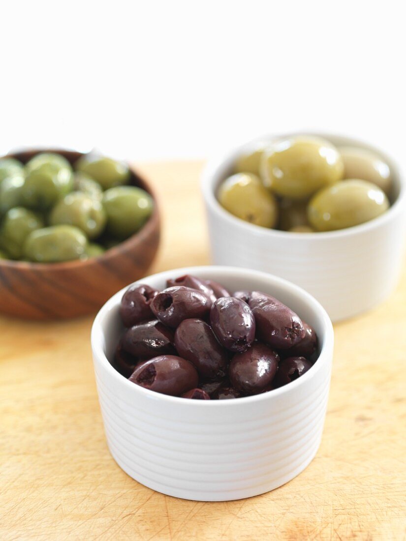 Various types of olives in dishes