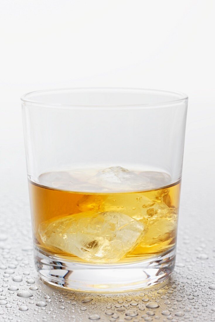 Whisky and ice cubes in a glass