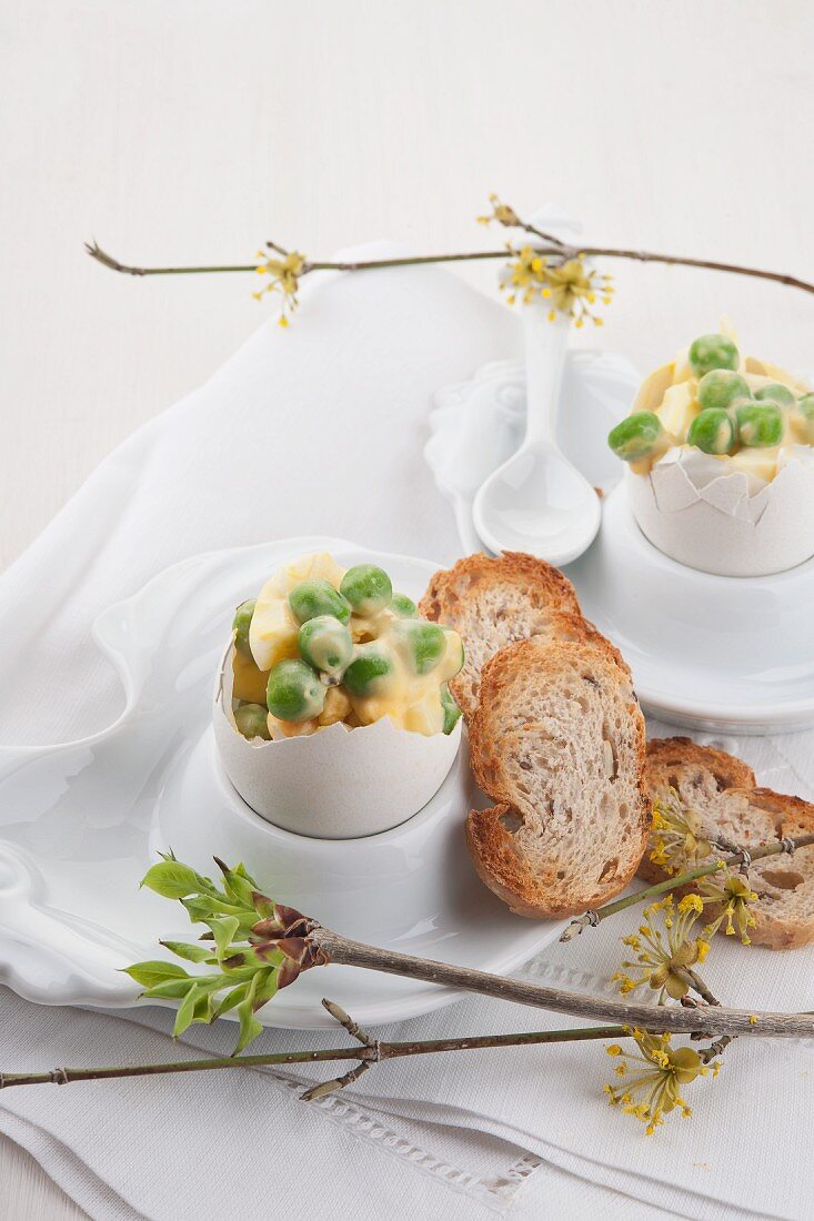 Peas with boiled egg and mayonnaise served in egg shells