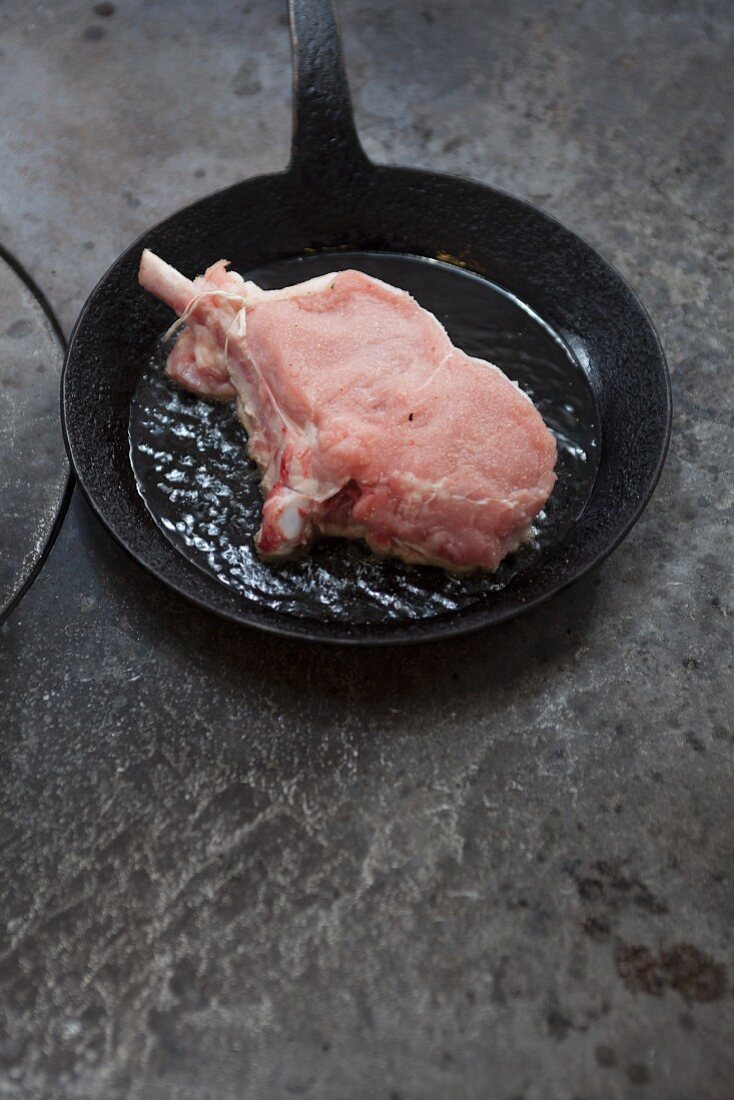 A veal chop in a pan