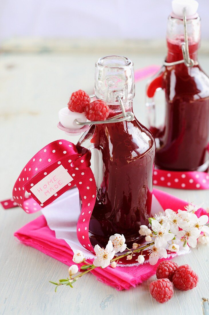 Homemade raspberry juice in small bottles