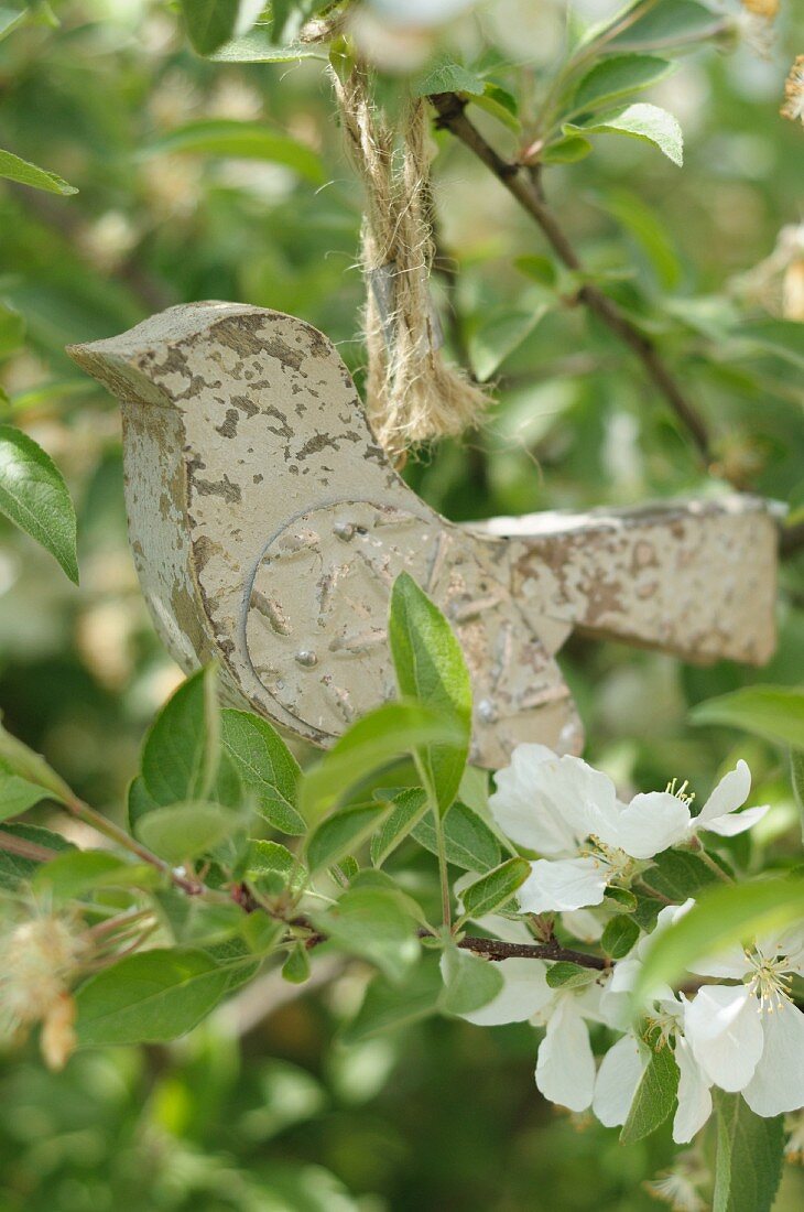 Wooden bird figurine on twig