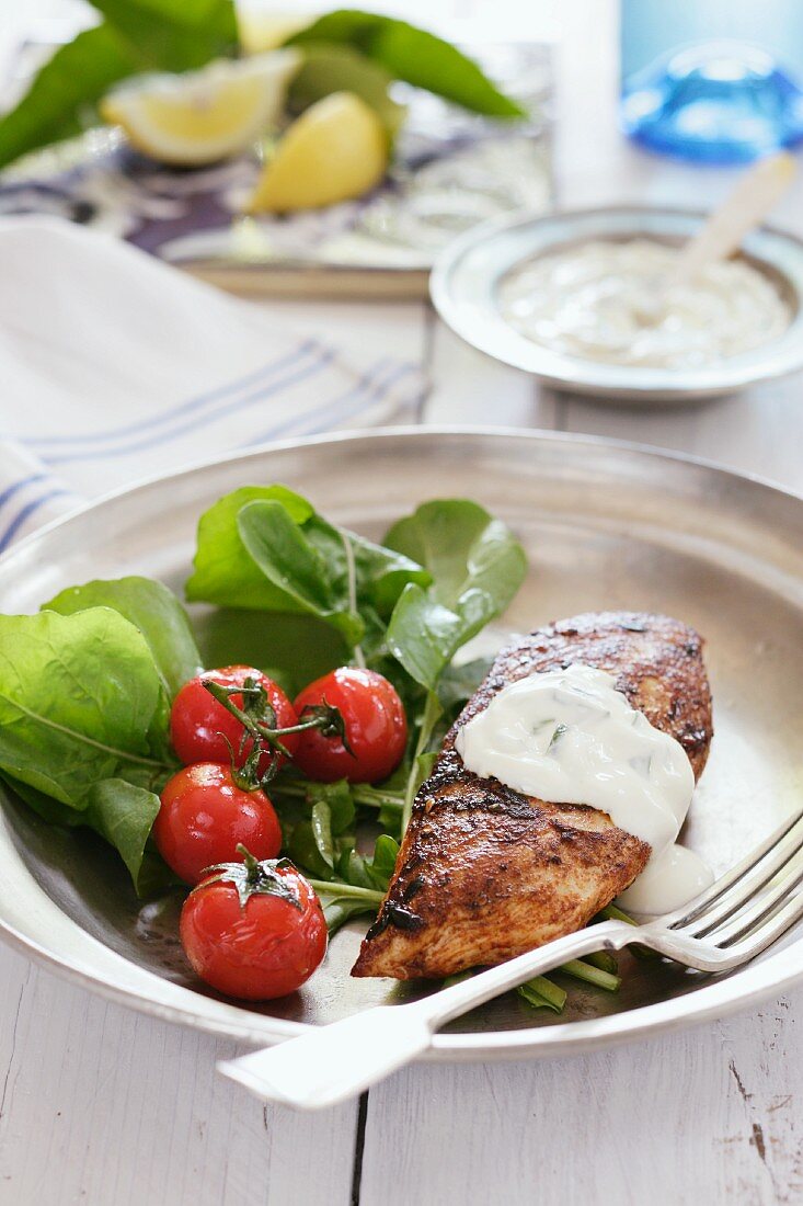 Grilled chicken breast with tzatziki and salad