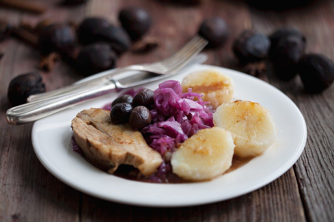 Roast pork with chestnuts, red cabbage and potato dumplings