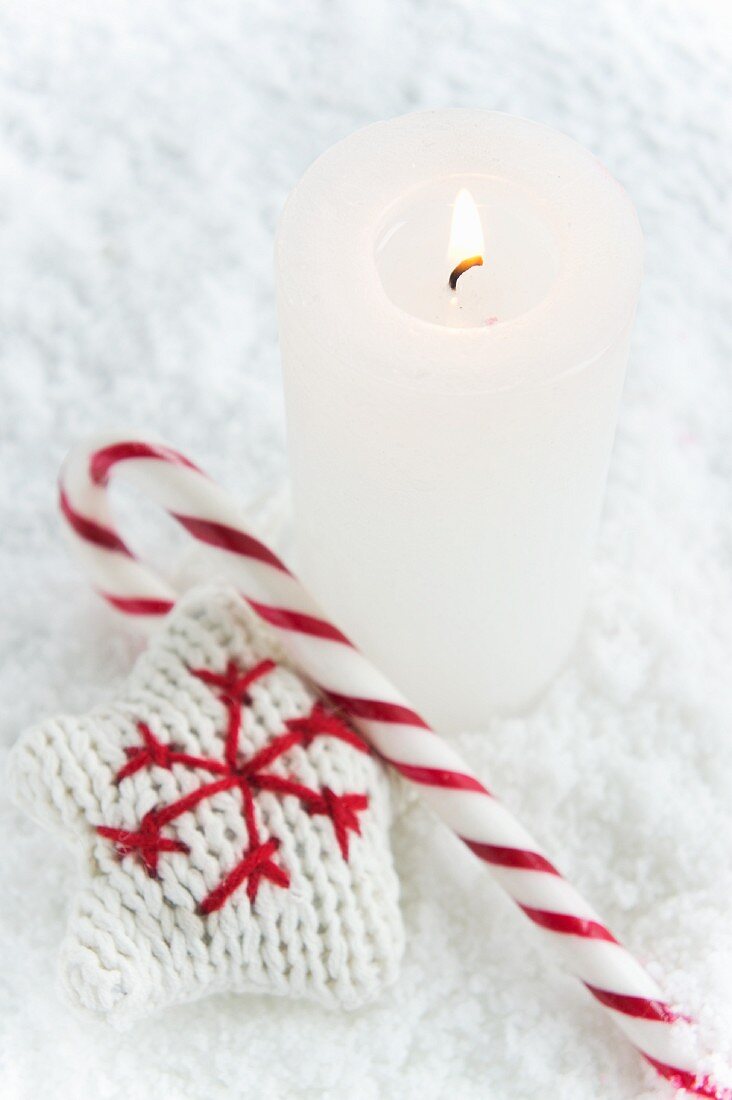 A candle, a candy cane and a knitted star