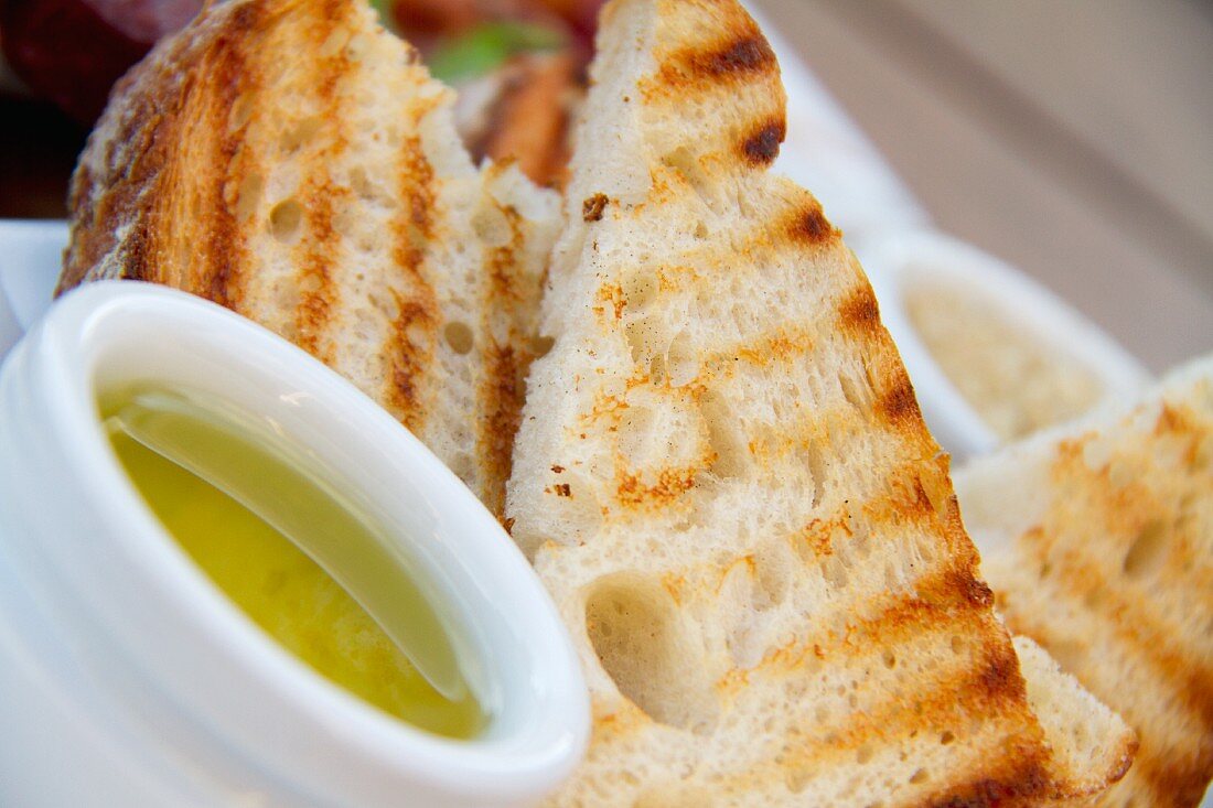 Grilled Bread Slices with a Small Bowl of Olive Oil