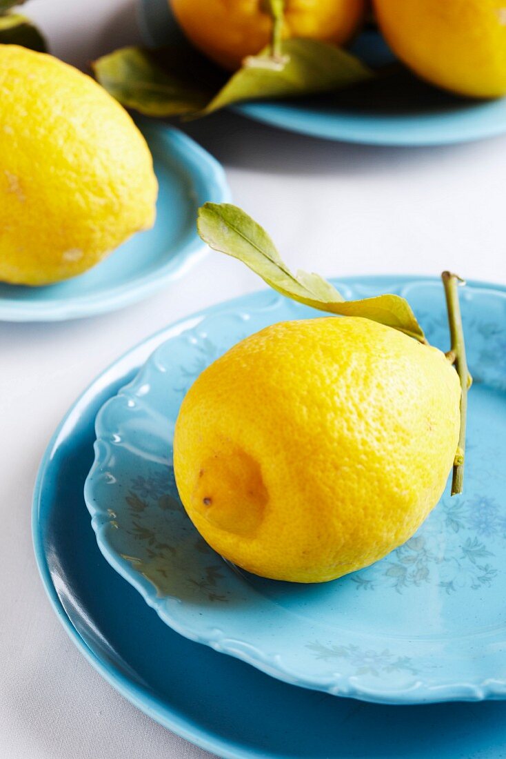 Organic lemons on blue plates