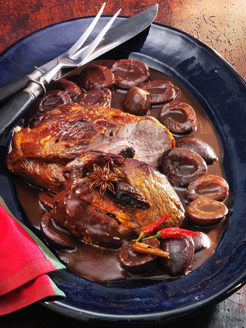 Pork neck in a spicy chocolate and damson sauce