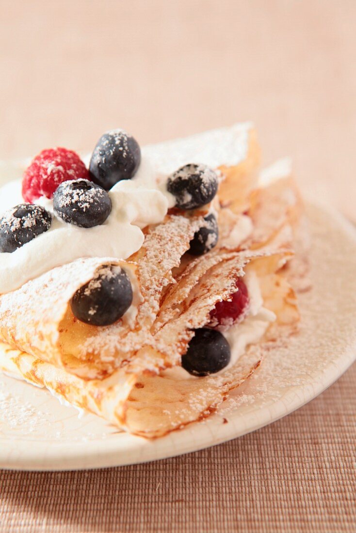 Pancakes with cream and fresh berries