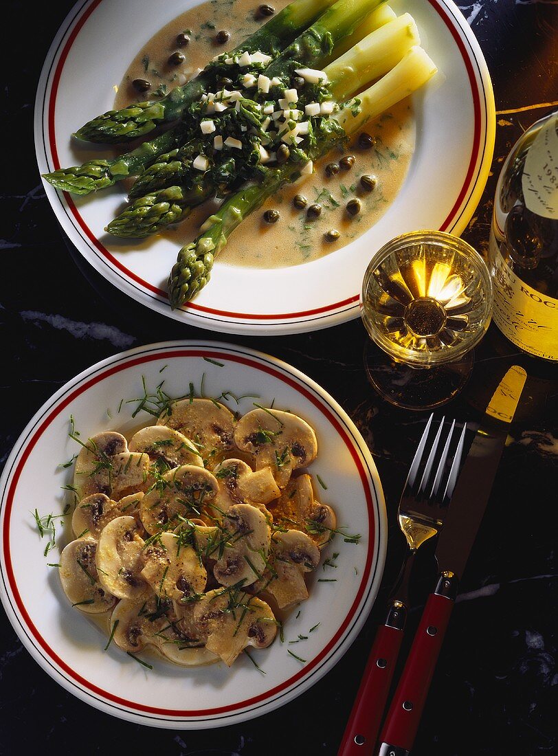 Green asparagus in oil & vinegar sauce with capers on plate