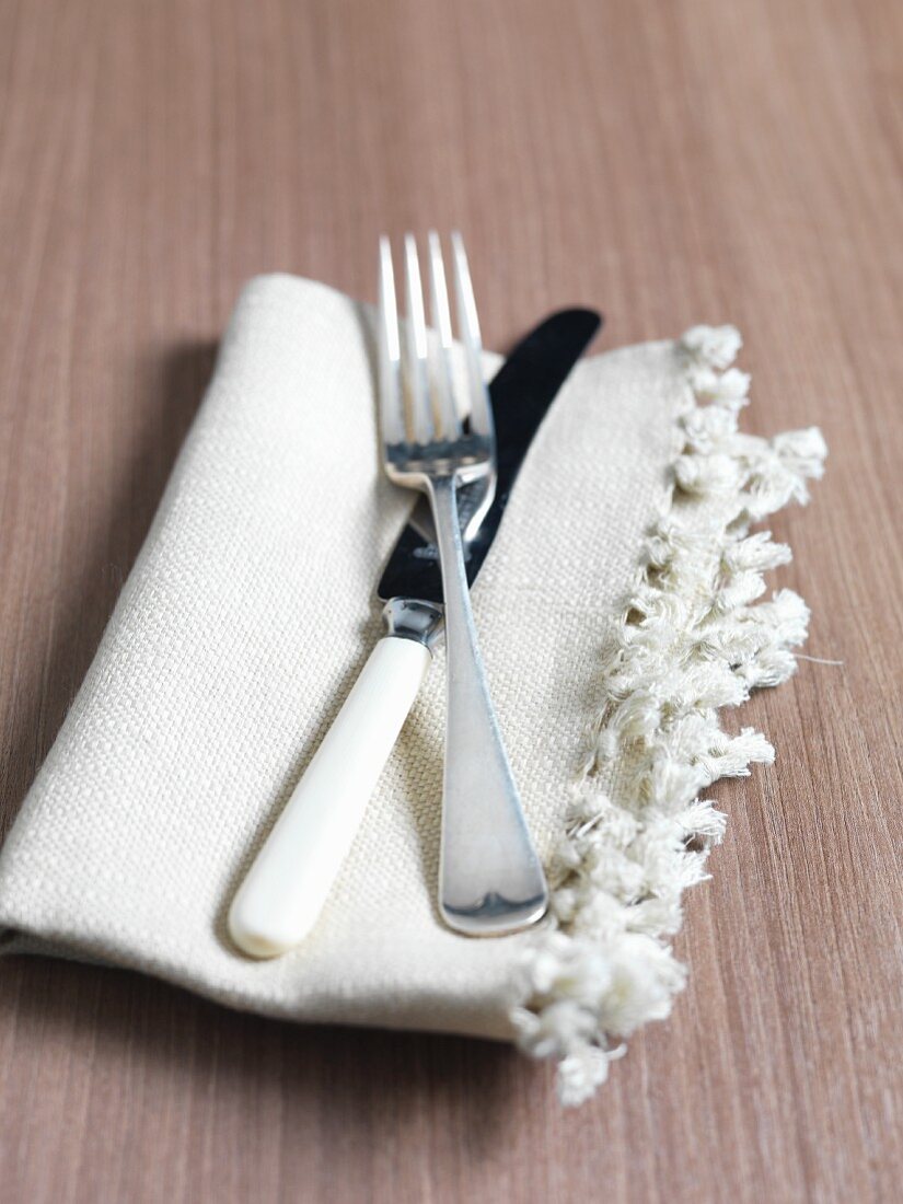 A knife and fork on a napkin