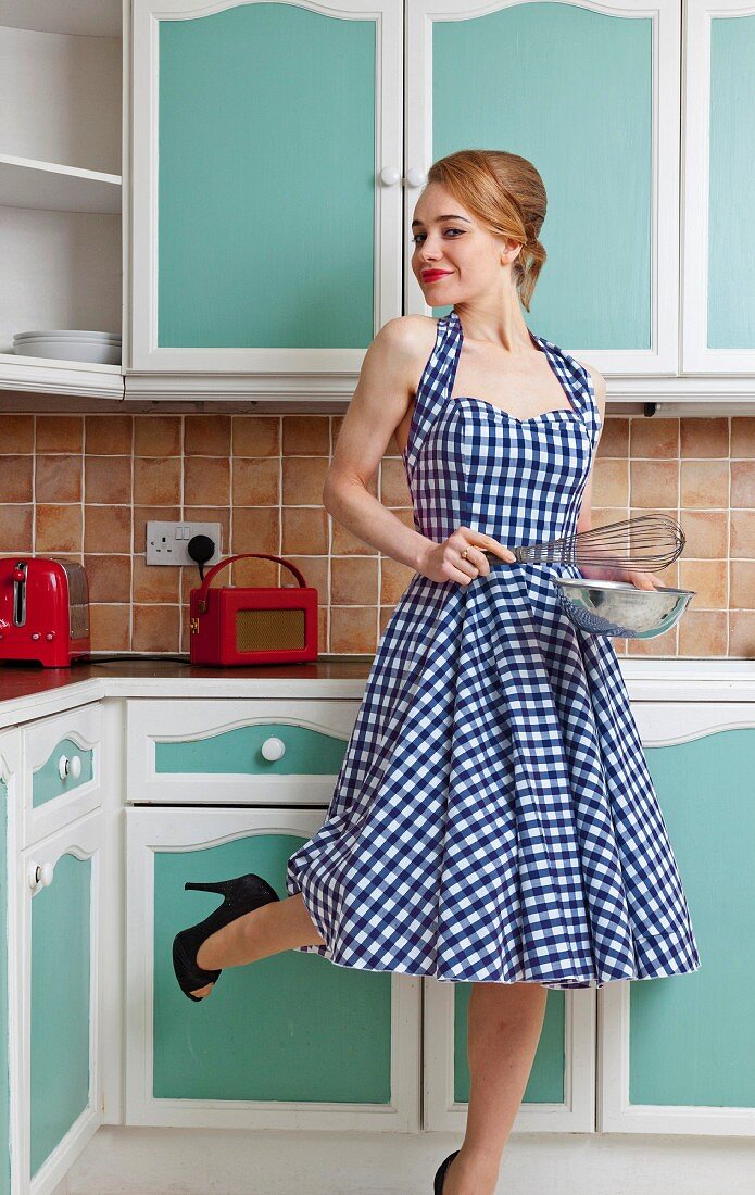 Smiling woman cooking in kitchen