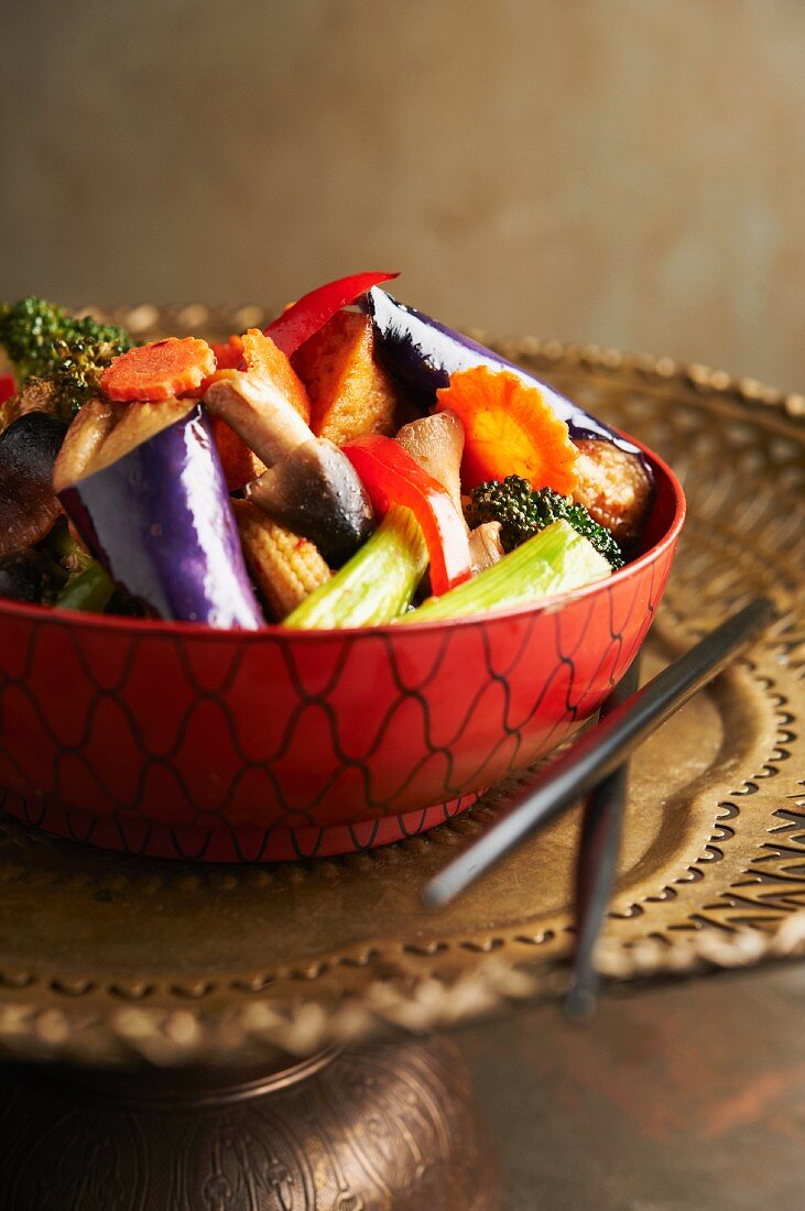 Thai Eggplant with Tofu and Vegetable Over a Bowl of Rice;Chopsticks