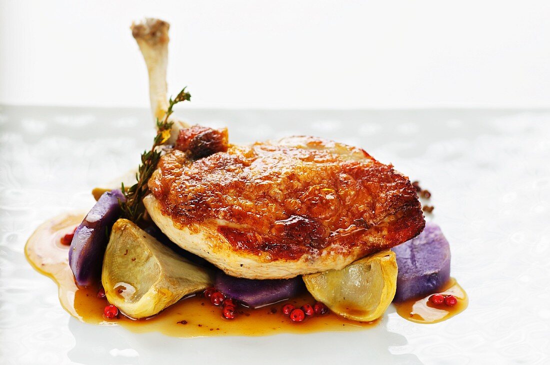 Roast chicken with purple potatoes and artichokes