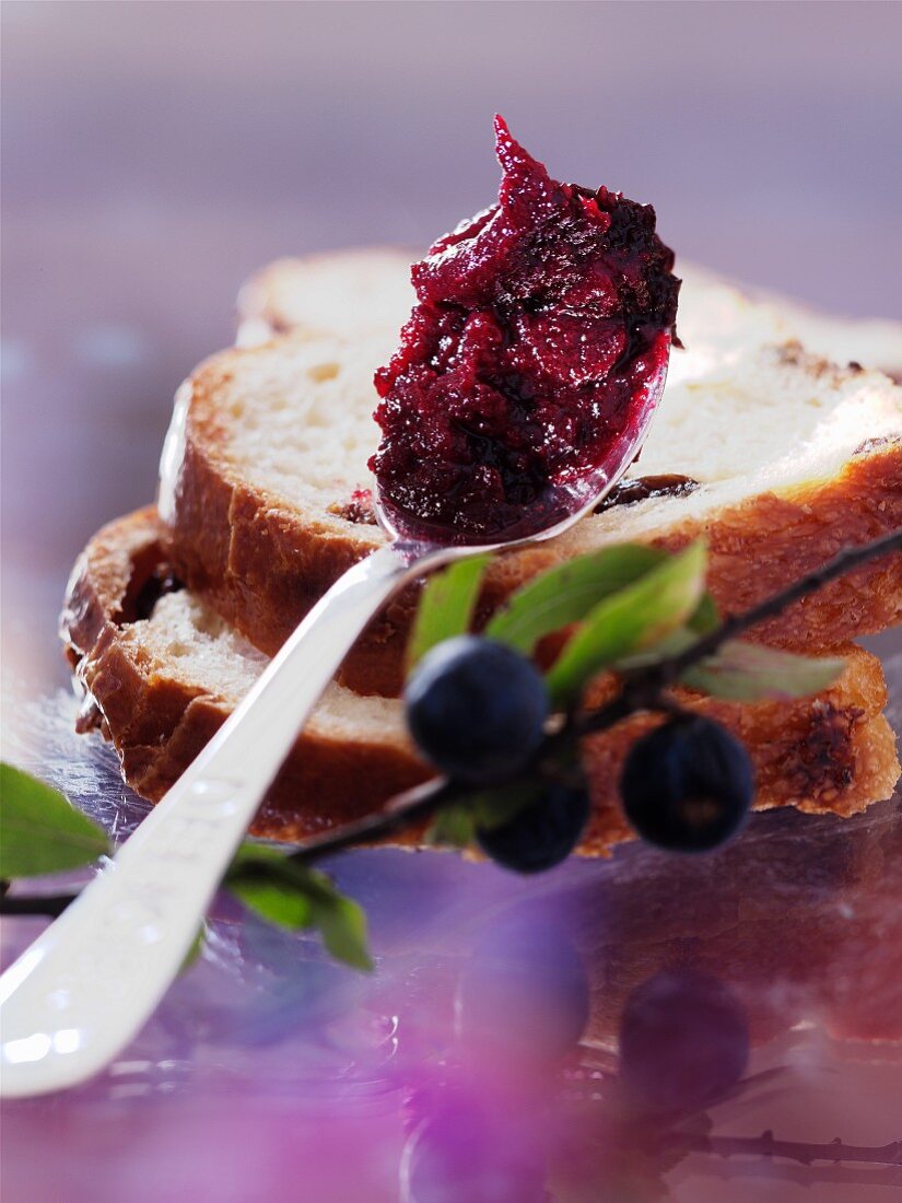 A spoonful of sloe jam and two slices of raisin bread