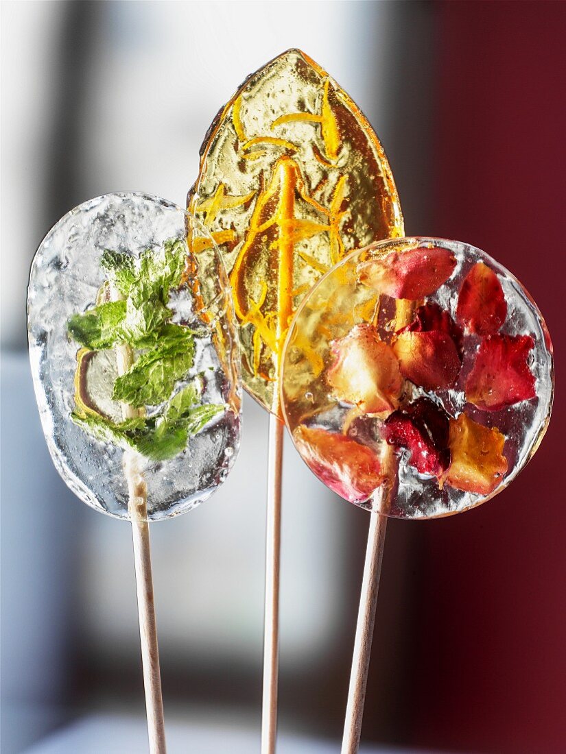 Homemade lollies with herbs, zest and fruit pieces
