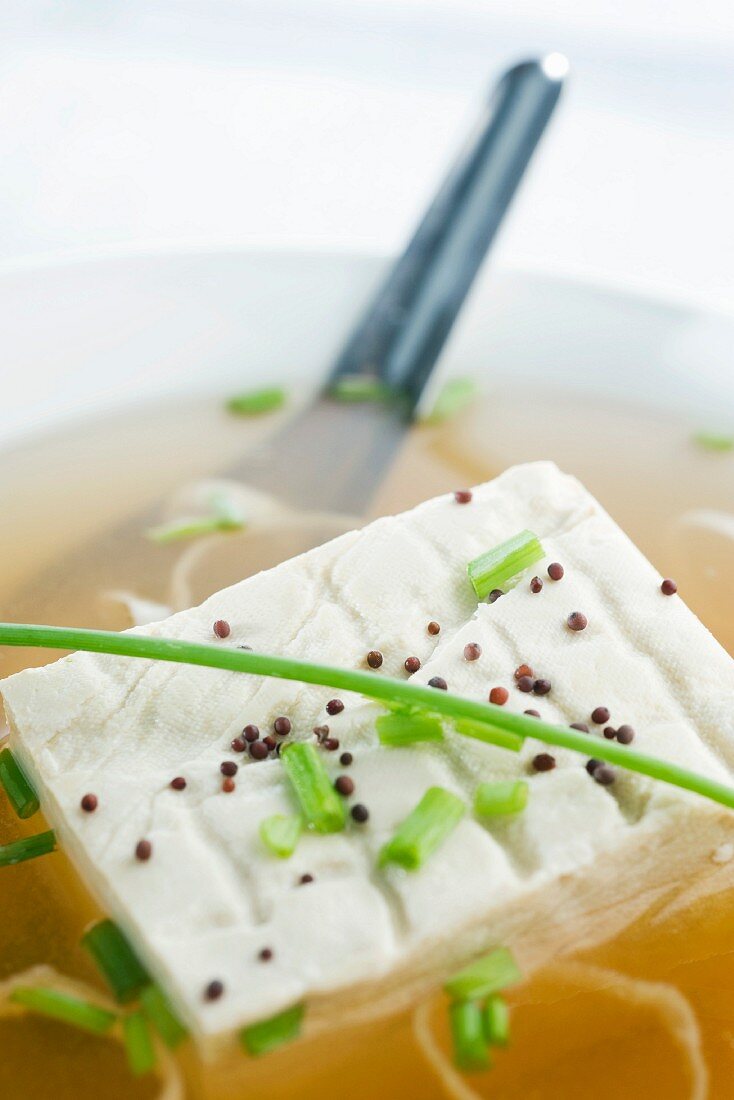 Block of tofu in miso soup, close-up