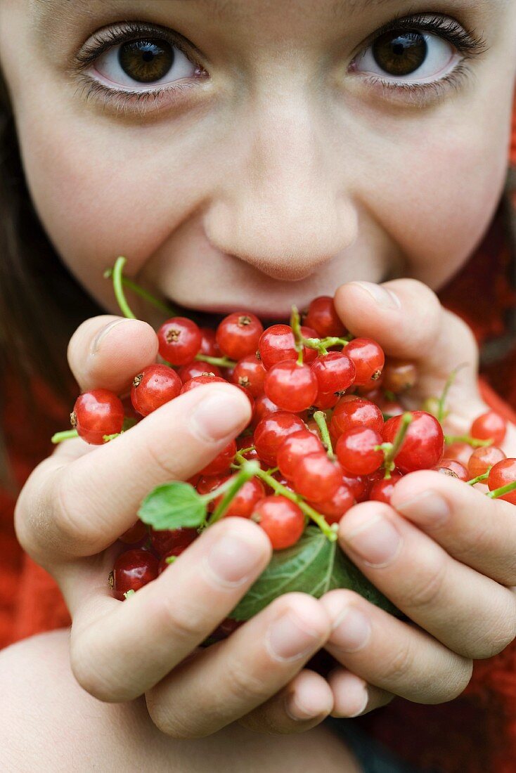 Girl holding redcurrants