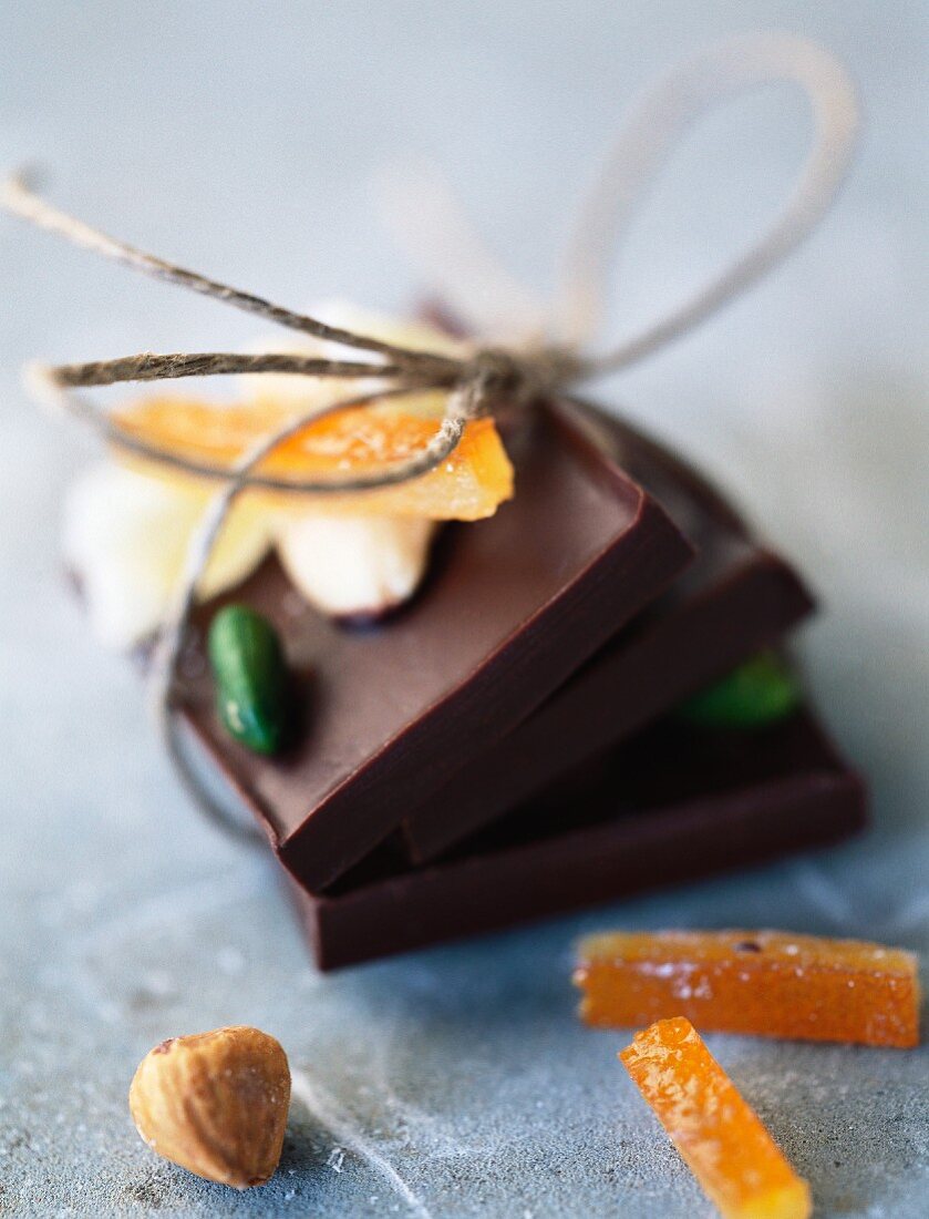 Chocolate bars tied together with string, candied fruit, hazelnut