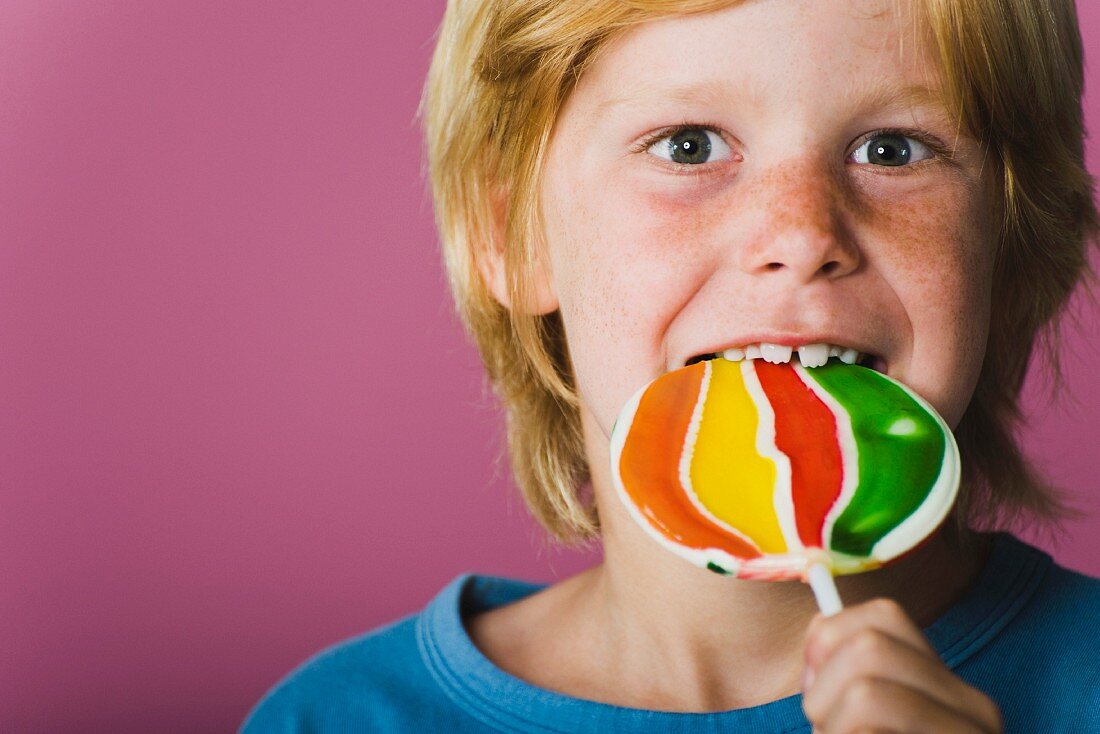 Boy eating lollipop, portrait