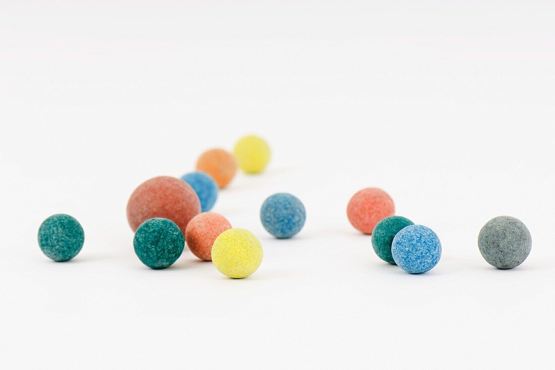 Colorful balls scattered over white surface