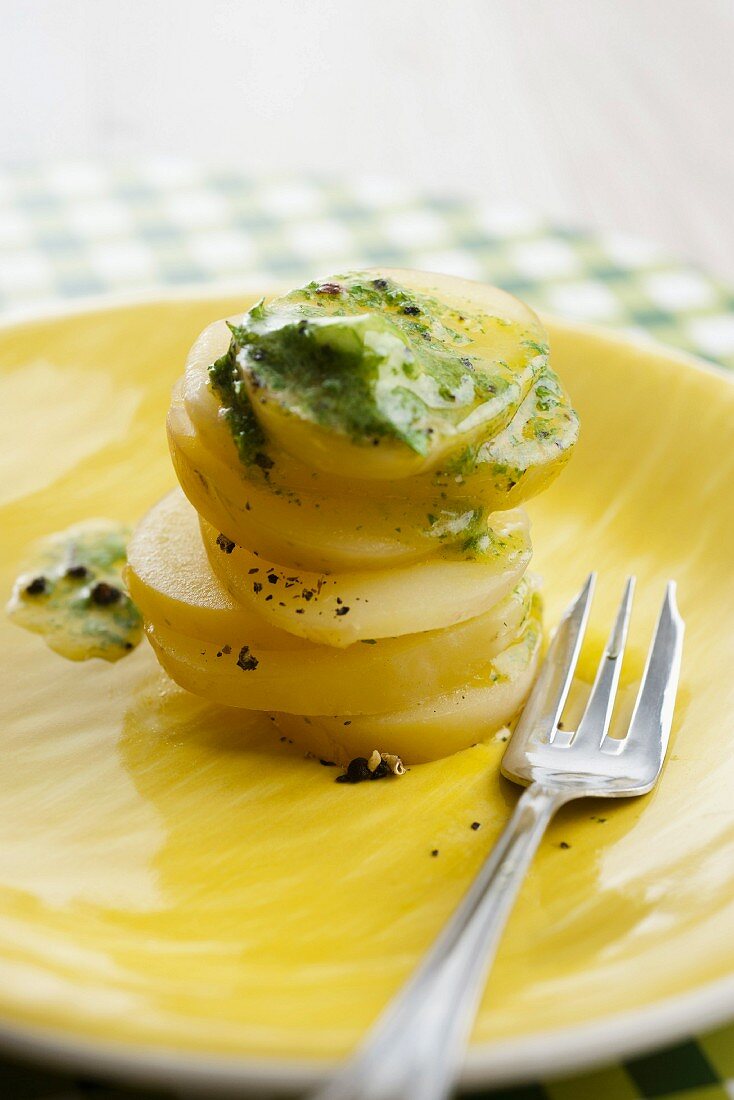 Sliced potatoes with stinging nettle butter