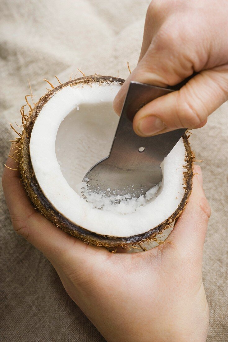 A coconut being hollowed out