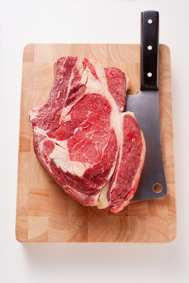 A slice of rib-eye steak on a chopping board