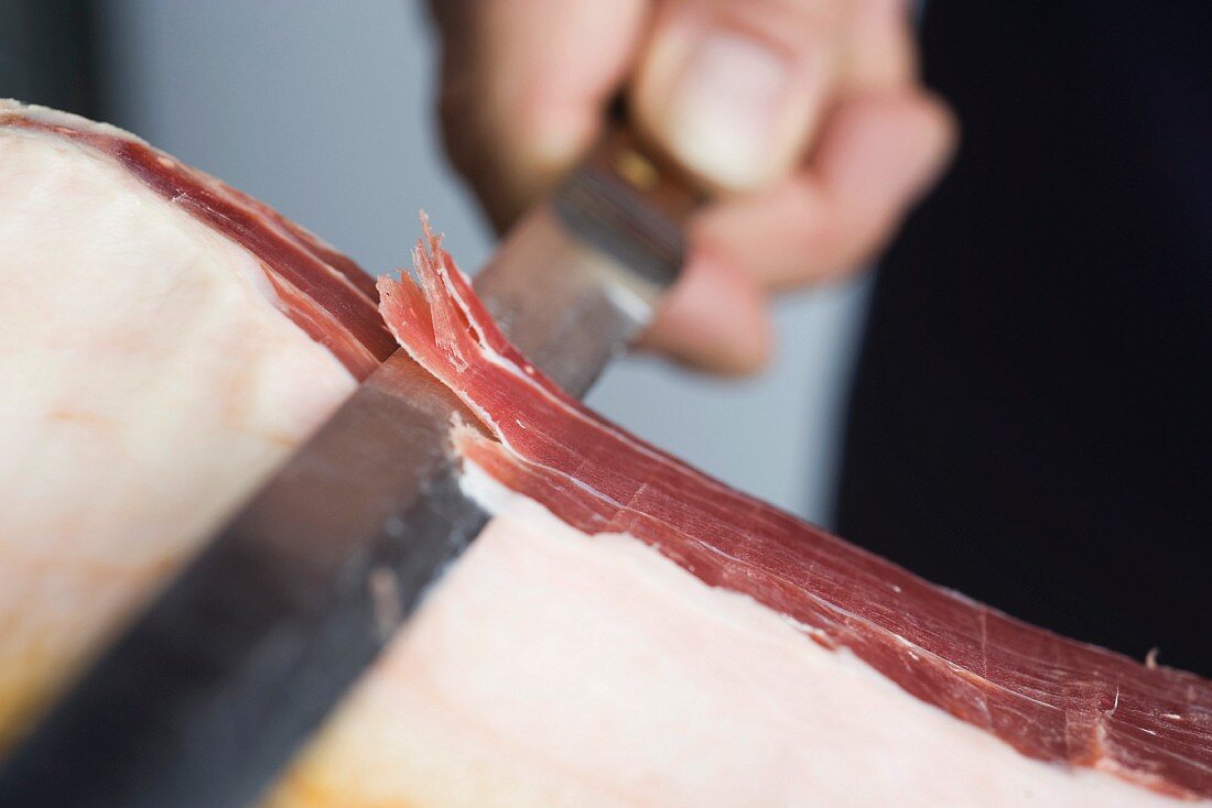 Prosciutto being sliced