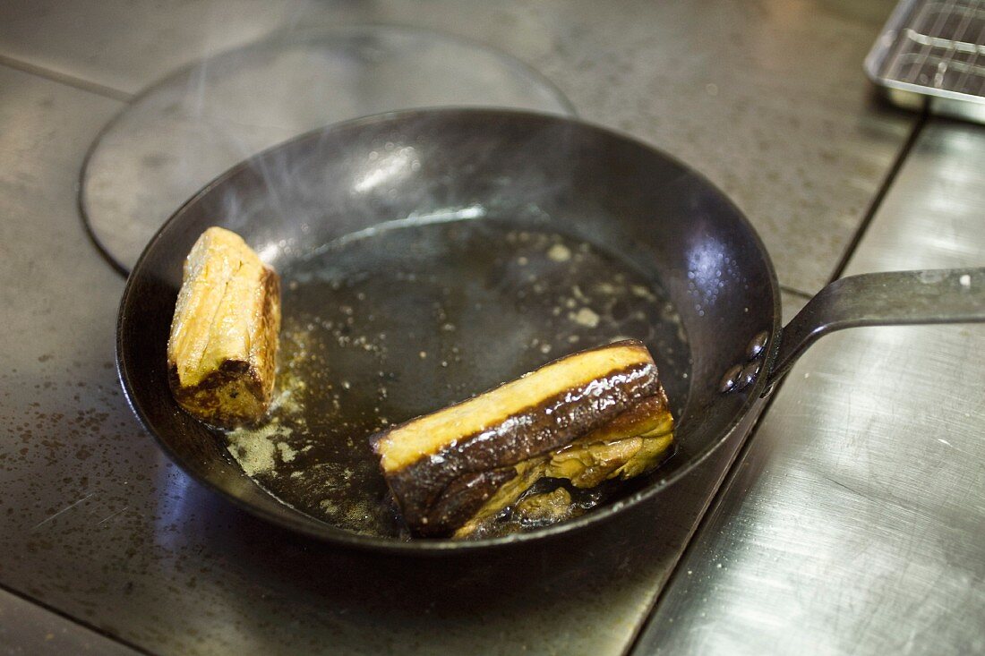 Goose liver being fried in a pan