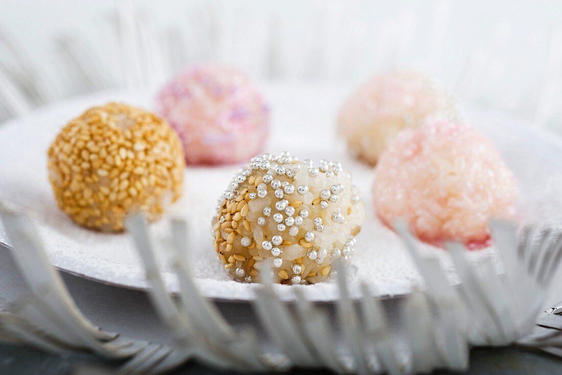 Sticky rice dumplings decorated with sesame seeds and silver balls (Asia)